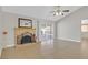 Living room area featuring a brick fireplace, sliding glass doors, and tile flooring at 3692 Rawhide Ct, Las Vegas, NV 89120