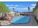 Backyard swimming pool with decorative rock waterfall feature, patio area, landscaping and palm trees at 3692 Rawhide Ct, Las Vegas, NV 89120
