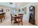 Elegant dining room featuring a wooden table, chandelier lighting, and a classic grandfather clock at 3788 Forestcrest Dr, Las Vegas, NV 89121