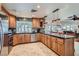 Well-equipped kitchen with custom wood cabinetry, stainless steel appliances, and a granite breakfast bar at 3788 Forestcrest Dr, Las Vegas, NV 89121