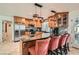 Well-equipped kitchen with custom wood cabinetry, stainless steel appliances, and a granite breakfast bar at 3788 Forestcrest Dr, Las Vegas, NV 89121