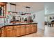 Spacious kitchen island with wooden cabinets, granite countertops, and decorative pendant lighting at 3788 Forestcrest Dr, Las Vegas, NV 89121