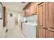 Functional laundry room with washer, dryer, cabinets, and ample storage space at 3788 Forestcrest Dr, Las Vegas, NV 89121