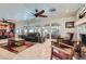 Cozy living room with stone fireplace, comfortable seating, and large windows overlooking the backyard at 3788 Forestcrest Dr, Las Vegas, NV 89121