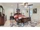 Well-lit main bedroom featuring a four-poster bed, wooden furniture, and a floral area rug at 3788 Forestcrest Dr, Las Vegas, NV 89121