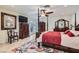 Bright main bedroom with four-poster bed, wooden dresser, and access to the outdoors at 3788 Forestcrest Dr, Las Vegas, NV 89121