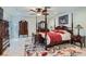 Main bedroom with four-poster bed, floral rug, and classic wooden furniture at 3788 Forestcrest Dr, Las Vegas, NV 89121
