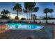 Backyard pool with stone decking, and desert landscaping featuring palm trees at 3788 Forestcrest Dr, Las Vegas, NV 89121