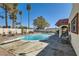 Backyard featuring a sparkling blue swimming pool, diving board, and stone patio at 3788 Forestcrest Dr, Las Vegas, NV 89121