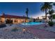 Backyard pool with stone decking, desert landscaping and a covered patio at 3788 Forestcrest Dr, Las Vegas, NV 89121