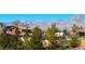 Backyard view showcasing lush green trees and mountain views, with a glimpse of the neighborhood at 3809 Vincelli Ave, North Las Vegas, NV 89031