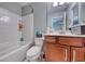 Bright bathroom with a white tiled shower-tub combination and modern vanity at 3809 Vincelli Ave, North Las Vegas, NV 89031