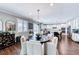 Well-lit dining area boasts modern chandelier, wood floors, plantation shutters, and open floor plan at 3809 Vincelli Ave, North Las Vegas, NV 89031