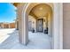 Inviting arched entryway leads to a decorative front door, with a three-car garage at 3809 Vincelli Ave, North Las Vegas, NV 89031