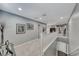 Bright upstairs hallway with neutral colors and a white banister leading to the stairway at 3809 Vincelli Ave, North Las Vegas, NV 89031