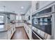 Gourmet kitchen featuring granite countertops, white cabinetry, and stainless steel appliances at 3809 Vincelli Ave, North Las Vegas, NV 89031