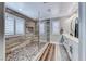 Beautiful ensuite bathroom boasting a large walk-in shower and dual sink vanity with neutral color palette at 3809 Vincelli Ave, North Las Vegas, NV 89031