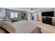 Large main bedroom showcasing ample space, sliding barn door to bathroom, and modern furnishings at 3809 Vincelli Ave, North Las Vegas, NV 89031