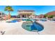 Backyard with a custom pool, spa, lounge area, outdoor kitchen, and ample space for entertaining on a sunny day at 3809 Vincelli Ave, North Las Vegas, NV 89031