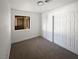 A bedroom with tan carpet, a closet, and window offers natural light at 3829 Soda Springs Dr, Las Vegas, NV 89115