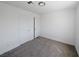 A bedroom with gray carpet and white walls offers a simple design at 3829 Soda Springs Dr, Las Vegas, NV 89115