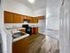 Modern kitchen with wood cabinets, new appliances, white countertops, and updated flooring at 3829 Soda Springs Dr, Las Vegas, NV 89115