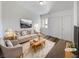 Inviting, virtually staged living room featuring neutral tones, plush furnishings, and bright, natural light at 3829 Soda Springs Dr, Las Vegas, NV 89115