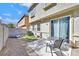 Cozy backyard featuring a patio area, a small table with chairs, and a partial view of adjacent buildings at 3920 Sweet Pine St # 102, Las Vegas, NV 89108
