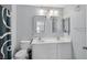 Bright bathroom features a double sink vanity with mirrors and a toilet at 3920 Sweet Pine St # 102, Las Vegas, NV 89108