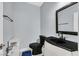 A powder room features a black toilet and sink with a marble-top cabinet at 3920 Sweet Pine St # 102, Las Vegas, NV 89108