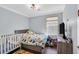 Bedroom featuring a full-sized bed, crib, and carpeted flooring at 3920 Sweet Pine St # 102, Las Vegas, NV 89108