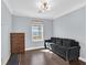 Spare bedroom featuring dark wood floors, a dark sofa and a dresser at 3920 Sweet Pine St # 102, Las Vegas, NV 89108