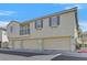 Spacious three-story townhome with three-car garage and neutral exterior paint at 3920 Sweet Pine St # 102, Las Vegas, NV 89108