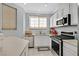 Efficient kitchen with stainless steel appliances, white cabinets, and granite countertops at 3920 Sweet Pine St # 102, Las Vegas, NV 89108