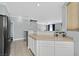Open kitchen featuring tiled flooring, white cabinetry, and views of the staircase at 3920 Sweet Pine St # 102, Las Vegas, NV 89108