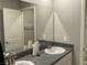 Bathroom featuring granite counters, dual sinks, and a large mirror at 4243 Sago Lily St, Las Vegas, NV 89129