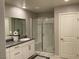 Modern bathroom featuring a glass shower, granite vanity, and tiled flooring at 4243 Sago Lily St, Las Vegas, NV 89129
