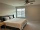 Bright bedroom with a ceiling fan, large window, and comfortable bed at 4243 Sago Lily St, Las Vegas, NV 89129