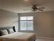 Cozy bedroom with a ceiling fan, large window, and comfortable bed at 4243 Sago Lily St, Las Vegas, NV 89129