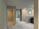 Bright hallway featuring neutral paint, plush carpet and multiple doorways at 4243 Sago Lily St, Las Vegas, NV 89129