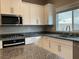 Modern kitchen with stainless appliances, granite countertops, and bright white cabinets at 4243 Sago Lily St, Las Vegas, NV 89129