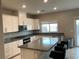 Bright kitchen featuring granite countertops, white cabinets, and modern stainless steel appliances at 4243 Sago Lily St, Las Vegas, NV 89129