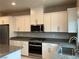Updated kitchen showcasing granite countertops, white cabinetry, and stainless steel appliances at 4243 Sago Lily St, Las Vegas, NV 89129