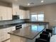 Kitchen boasting granite countertops, stainless steel appliances, and a kitchen island with barstool seating at 4243 Sago Lily St, Las Vegas, NV 89129