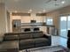 Open-concept living room and kitchen featuring modern furnishings and natural light at 4243 Sago Lily St, Las Vegas, NV 89129