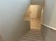Carpeted staircase leading to the home's front door with tile entry and neutral-toned walls at 4243 Sago Lily St, Las Vegas, NV 89129