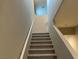 Carpeted staircase with white railings leading to the upper level at 4243 Sago Lily St, Las Vegas, NV 89129