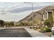 Street view of well-maintained homes with desert landscaping and mountain backdrop at 4243 Sago Lily St, Las Vegas, NV 89129