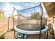 Backyard area featuring a trampoline and brick-paved area, perfect for Gathering enjoyment and outdoor activities at 4438 Faberge Ave, Las Vegas, NV 89115