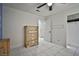 The bedroom has durable tile flooring, a ceiling fan, a dresser, and neutral paint at 4438 Faberge Ave, Las Vegas, NV 89115